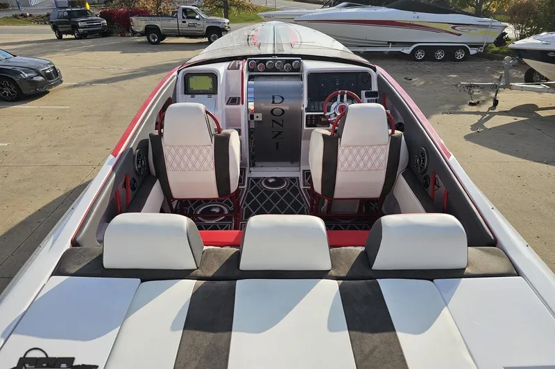 Slide: The Image of 2008 Donzi 38 ZR speedboat interior with white and red seating, dashboard, and steering wheel. - 35