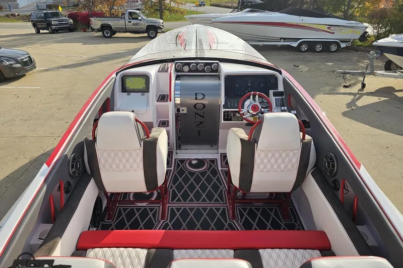 Slide: The Image of 2008 Donzi 38 ZR boat interior with red and white seating, dashboard, and steering wheel. - 36