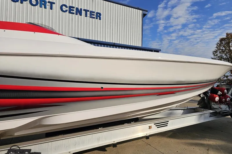 Slide: The Image of 2008 Donzi 38 ZR speedboat with red accents on trailer, near sport center. - 4