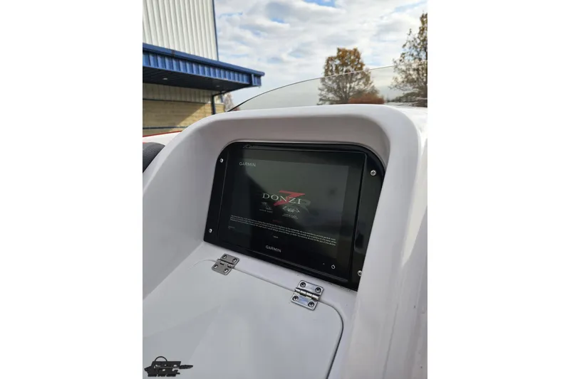 Slide: The Image of 2008 Donzi 38 ZR dashboard with Garmin display, outdoor setting. - 50