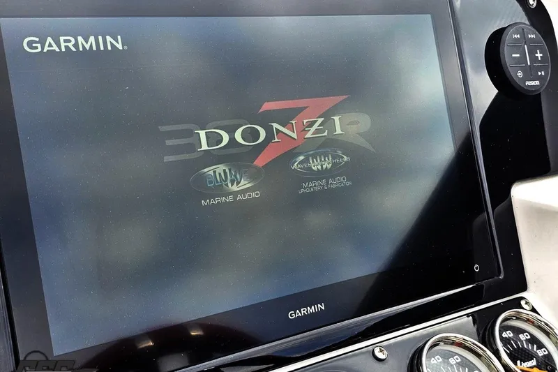 Slide: The Image of Garmin display on 2008 Donzi 38 ZR boat featuring marine audio controls. - 56