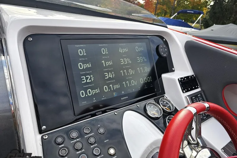Slide: The Image of Dashboard of a 2008 Donzi 38 ZR boat with digital display and red steering wheel. - 57