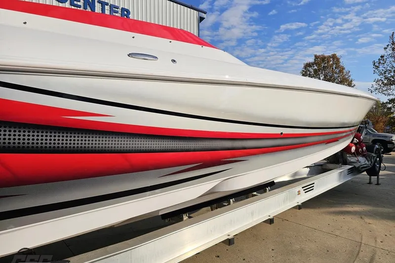 Slide: The Image of 2008 Donzi 38 ZR speedboat with red and black accents on a trailer. - 6