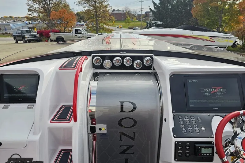 Slide: The Image of 2008 Donzi 38 ZR boat dashboard with Garmin displays and sleek design. - 61