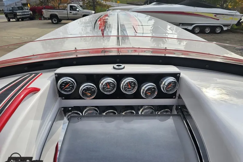 Slide: The Image of 2008 Donzi 38 ZR dashboard with gauges, sleek design, and red accents. - 62