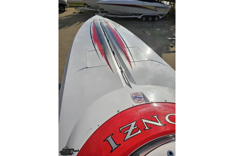 Slide: The Image of 2008 Donzi 38 ZR boat with sleek red and black design on deck. - 64