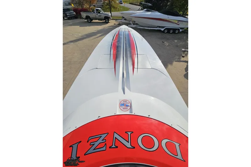 Slide: The Image of 2008 Donzi 38 ZR speedboat with red and black accents, parked outdoors. - 66