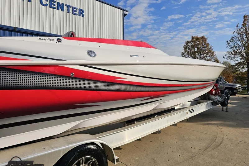 Slide: The Image of 2008 Donzi 38 ZR speedboat with red and white design on a trailer. - 7