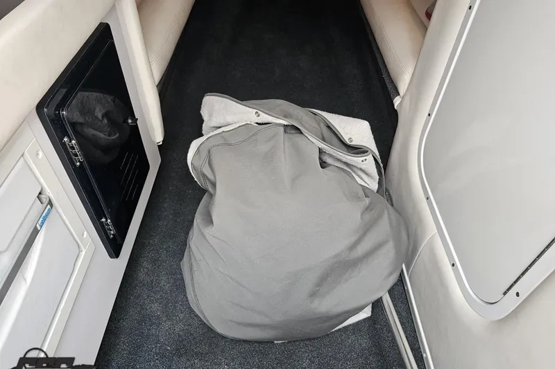 Slide: The Image of 2008 Donzi 38 ZR interior with gray bag on carpeted floor. - 75