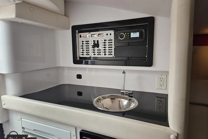 Slide: The Image of Interior of 2008 Donzi 38 ZR boat featuring control panel and sink. - 76