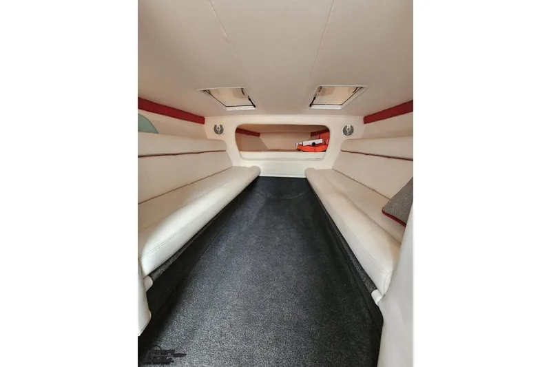 Slide: The Image of Interior of 2008 Donzi 38 ZR boat with white seating and carpeted floor. - 78