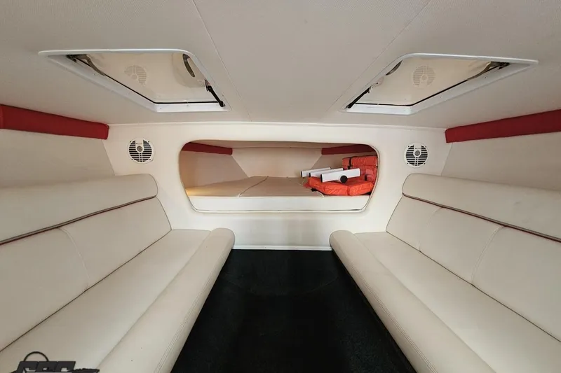 Slide: The Image of Interior of 2008 Donzi 38 ZR boat with white seating and storage area. - 79