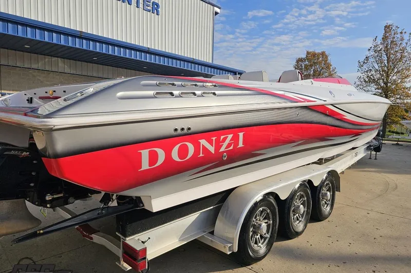 Slide: The Image of 2008 Donzi 38 ZR speedboat with red and silver design on a trailer. - 9