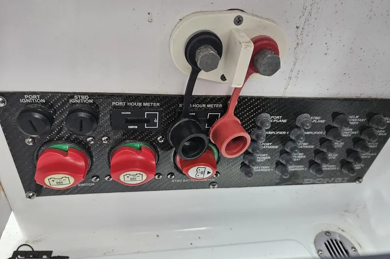 Slide: The Image of Control panel of a 2008 Donzi 38 ZR boat with ignition switches and hour meter. - 90