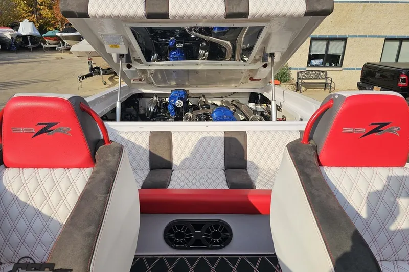 Slide: The Image of 2008 Donzi 38 ZR boat interior with open engine compartment, red and white seating. - 91