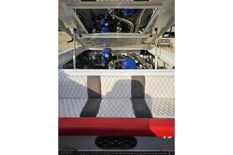 Slide: The Image of 2008 Donzi 38 ZR boat engine compartment with blue accents and quilted seating. - 92