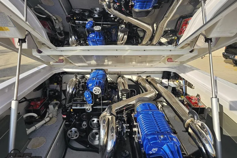 Slide: The Image of Engine compartment of a 2008 Donzi 38 ZR with blue and chrome components. - 93