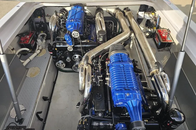 Slide: The Image of Engine compartment of a 2008 Donzi 38 ZR with dual blue engines and chrome exhausts. - 94