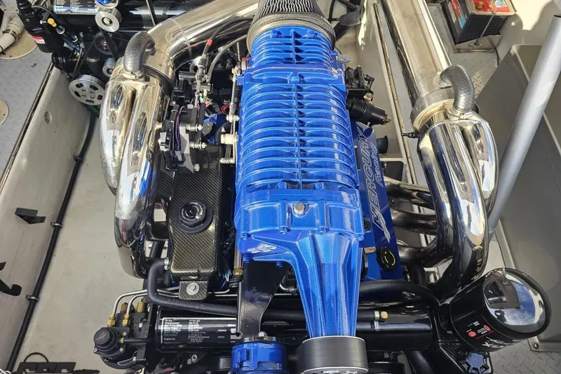Slide: The Image of Engine of a 2008 Donzi 38 ZR boat with blue and chrome components. - 95
