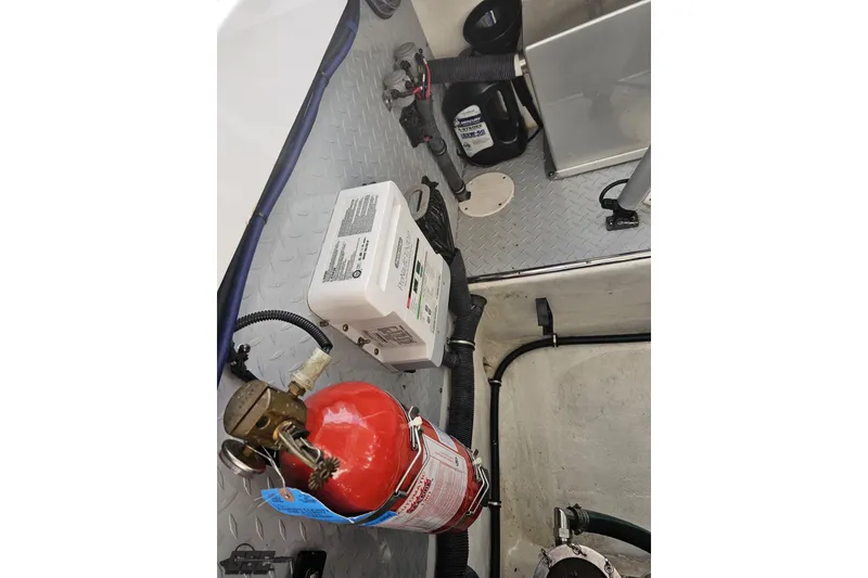 Slide: The Image of Interior of a 2008 Donzi 38 ZR boat showing equipment and fire extinguisher. - 97