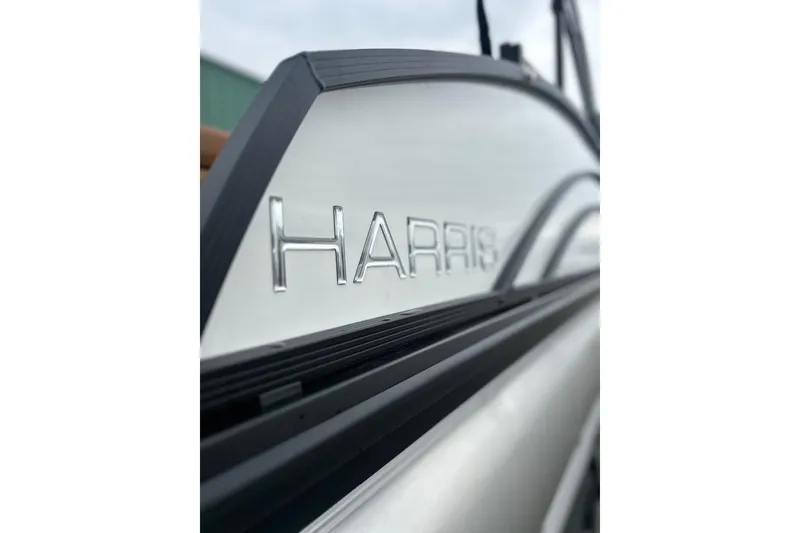 Slide: The Image of Close-up of 2026 Harris CRUISER 230 SL boat logo on sleek exterior. - 10