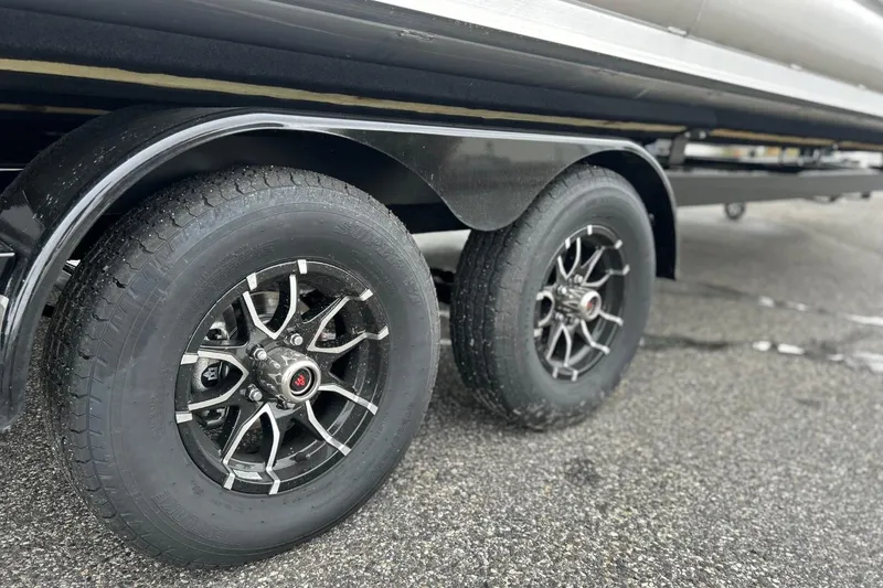 Slide: The Image of 2026 Harris CRUISER 230 SL trailer wheels on wet pavement. - 11