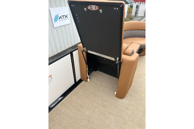 Slide: The Image of 2026 Harris CRUISER 230 SL boat interior with tan seating and storage compartment. - 20