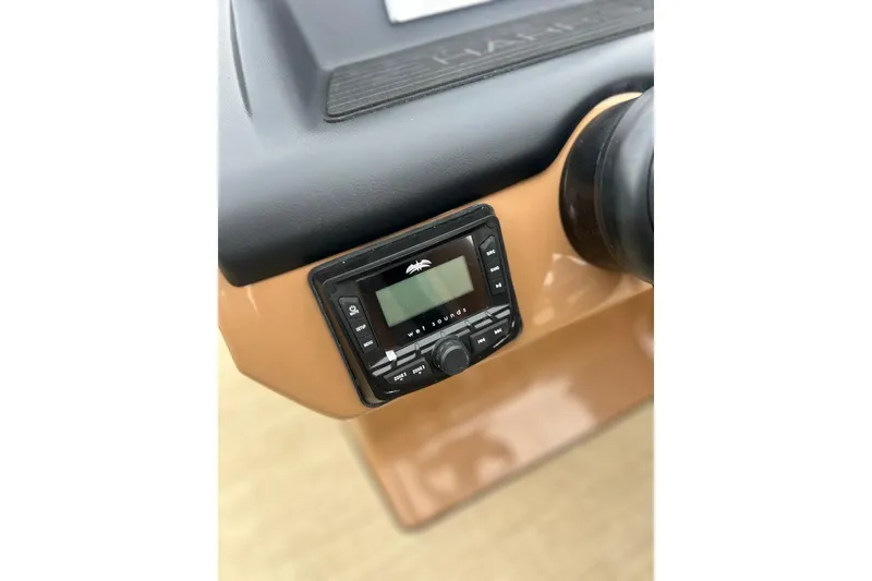 Slide: The Image of 2026 Harris CRUISER 230 SL dashboard with audio control panel. - 23