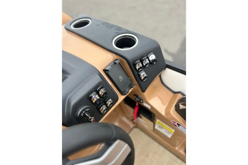 Slide: The Image of 2026 Harris CRUISER 230 SL dashboard with controls and cup holders. - 24