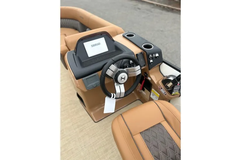Slide: The Image of 2026 Harris CRUISER 230 SL boat dashboard with steering wheel and Simrad display. - 27