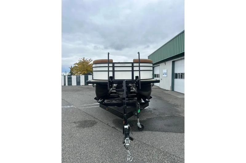 Slide: The Image of 2026 Harris CRUISER 230 SL boat on trailer, parked outside a garage. - 3