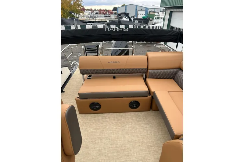 Slide: The Image of 2026 Harris CRUISER 230 SL boat interior with tan seating and black canopy. - 34