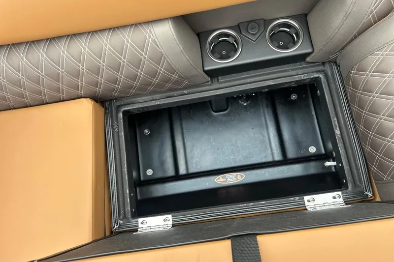 Slide: The Image of 2026 Harris CRUISER 230 SL storage compartment with cup holders and quilted upholstery. - 36