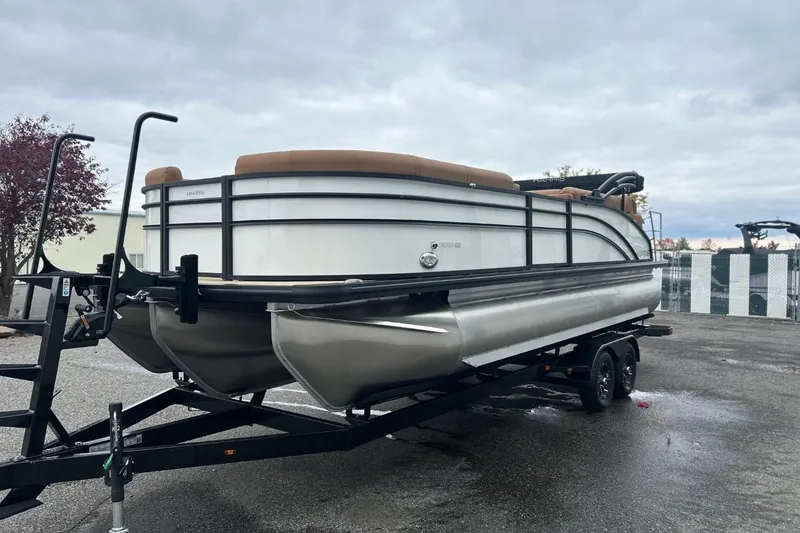 Slide: The Image of 2026 Harris CRUISER 230 SL pontoon boat on trailer, parked outdoors under cloudy sky. - 4