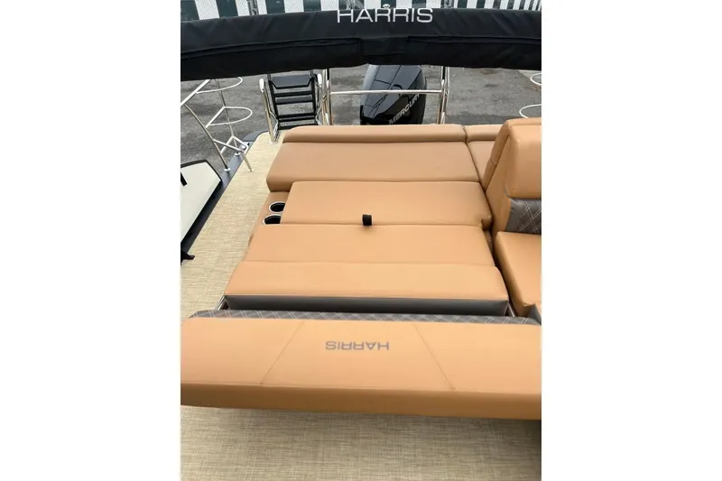 Slide: The Image of 2026 Harris CRUISER 230 SL boat interior with tan seating and cup holders. - 40
