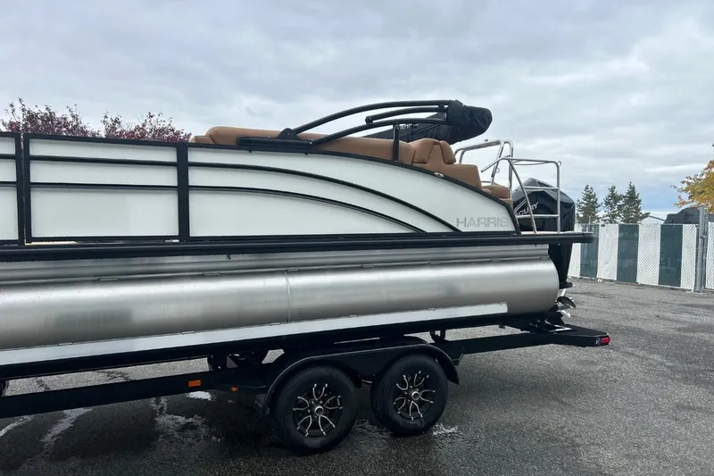 Slide: The Image of 2026 Harris CRUISER 230 SL pontoon boat on trailer, parked outdoors. - 6