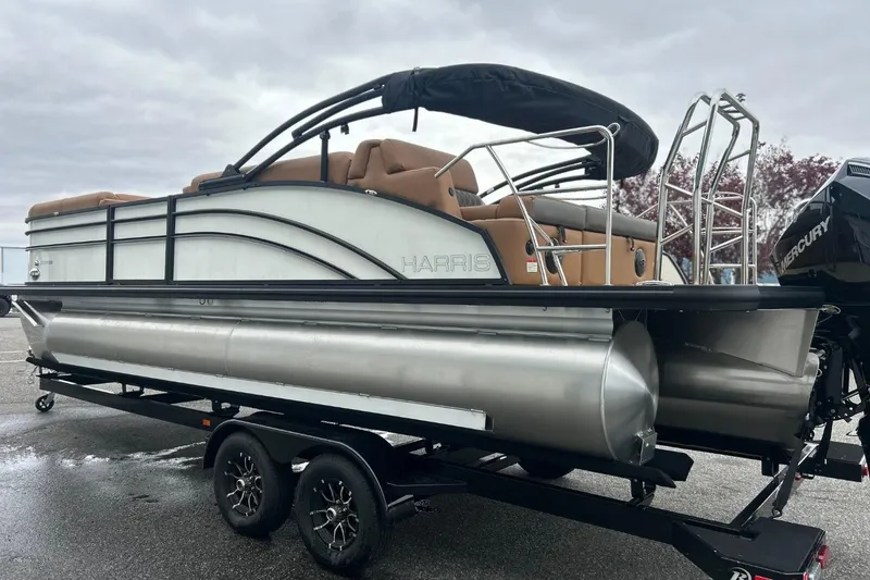 Slide: The Image of 2026 Harris CRUISER 230 SL pontoon boat on trailer, featuring sleek design and Mercury engine. - 7