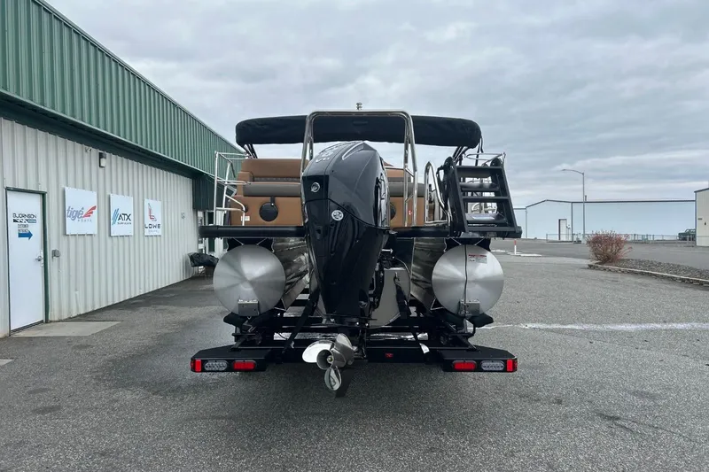 Slide: The Image of 2026 Harris CRUISER 230 SL pontoon boat parked outside a warehouse. - 8
