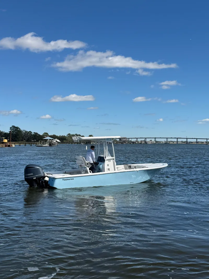 Slide: The Image of 2020 Tidewater 2300 Carolina Bay boat on calm water under blue sky. - 17