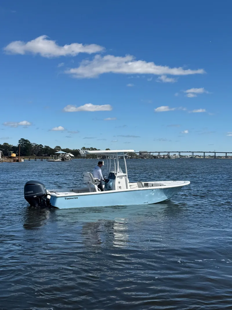 Slide: The Image of 2020 Tidewater 2300 Carolina Bay boat on calm water under blue sky. - 18