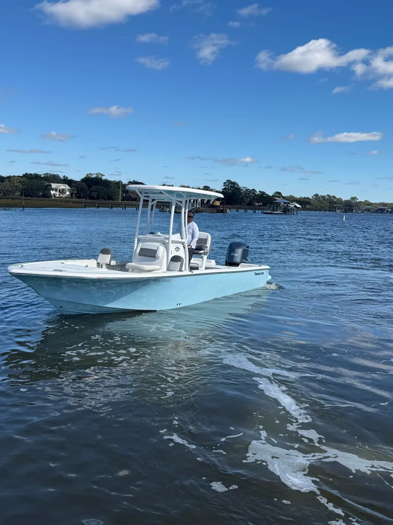 Slide: The Image of 2020 Tidewater 2300 Carolina Bay boat on calm water under blue sky. - 19
