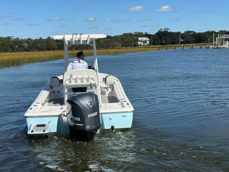 Slide: The Image of 2020 Tidewater 2300 Carolina Bay boat cruising on a calm river with scenic background. - 24