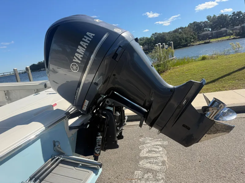 Slide: The Image of Yamaha outboard motor on 2020 Tidewater 2300 Carolina Bay boat by a scenic river. - 30