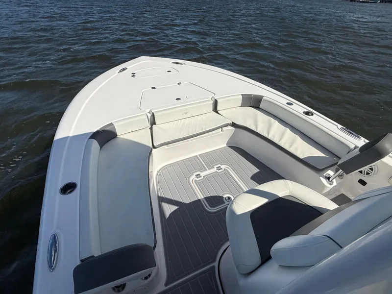 Slide: The Image of 2020 Tidewater 2300 Carolina Bay boat interior with seating, on calm water. - 43