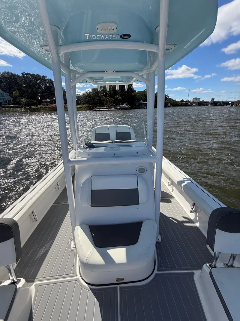 Slide: The Image of 2020 Tidewater 2300 Carolina Bay boat on water, featuring sleek seating and T-top. - 44