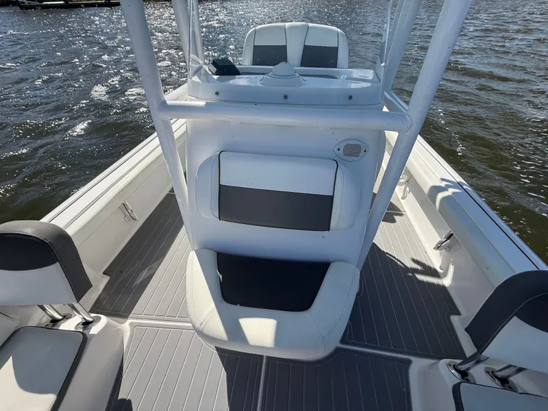 Slide: The Image of 2020 Tidewater 2300 Carolina Bay boat interior with seating and console on water. - 45