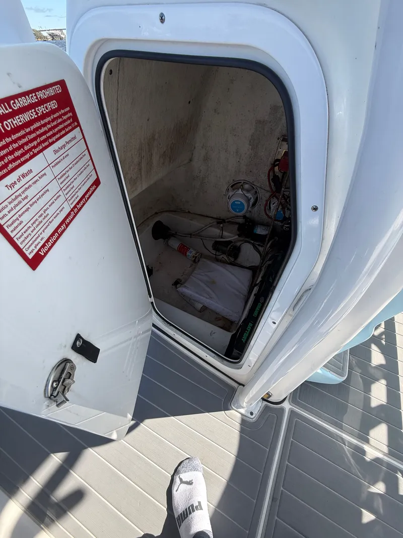 Slide: The Image of Open storage compartment on 2020 Tidewater 2300 Carolina Bay boat, showing interior equipment. - 48