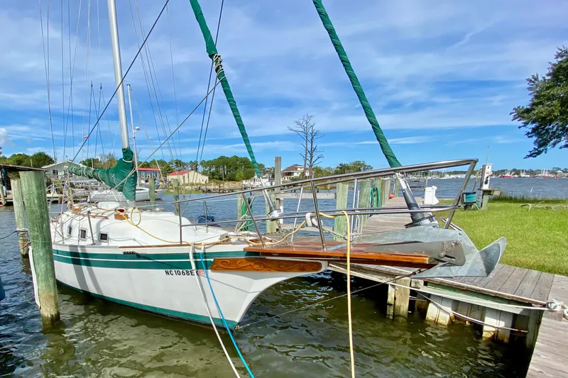 The Image of 1986 Bayfield 32 sailboat docked at a marina on a sunny day. - 1