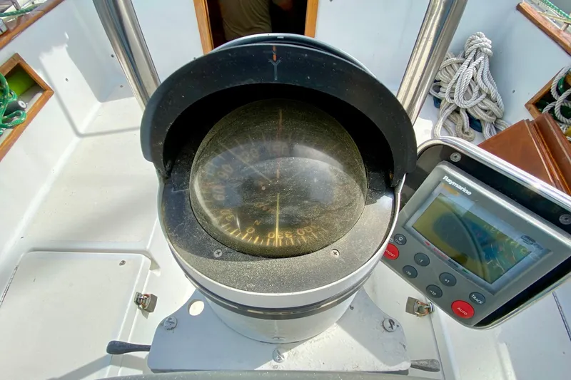 Slide: The Image of Compass and navigation equipment on 1986 Bayfield 32 sailboat deck. - 12