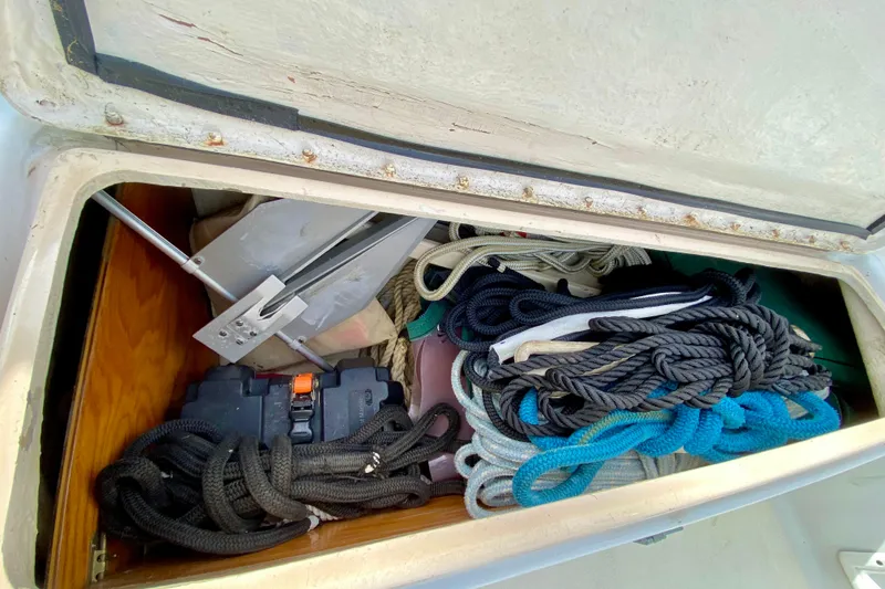 Slide: The Image of Storage compartment on a 1986 Bayfield 32 sailboat with ropes and anchor. - 13